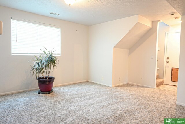 2412 Lewis And Clark Rd, Bellevue, NE 68123 - bonus room featuring a textured ceiling and carpet