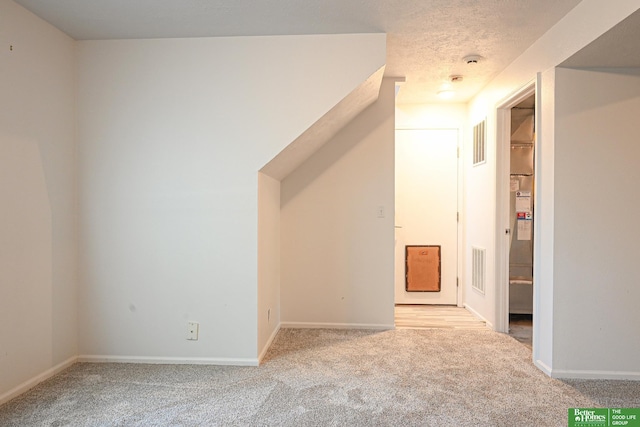2412 Lewis And Clark Rd, Bellevue, NE 68123 - bonus room featuring light carpet and a textured ceiling