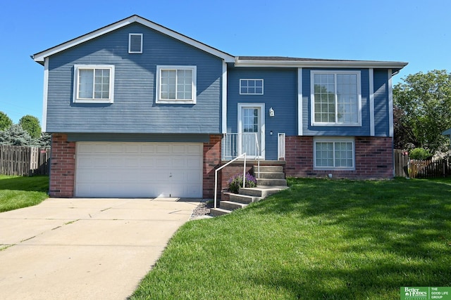 2412 Lewis And Clark Rd, Bellevue, NE 68123 - raised ranch featuring a garage, brick siding, and driveway