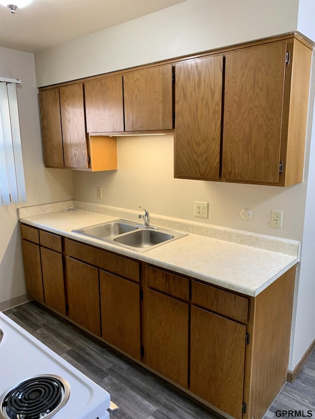 1321 D St, Lincoln, NE 68502 - kitchen featuring dark wood-style floors, light countertops, and stove