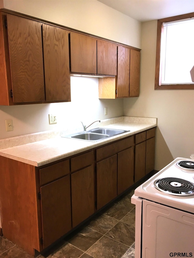 1321 D St, Lincoln, NE 68502 - kitchen featuring white electric range, light countertops, and dark stone finish flooring