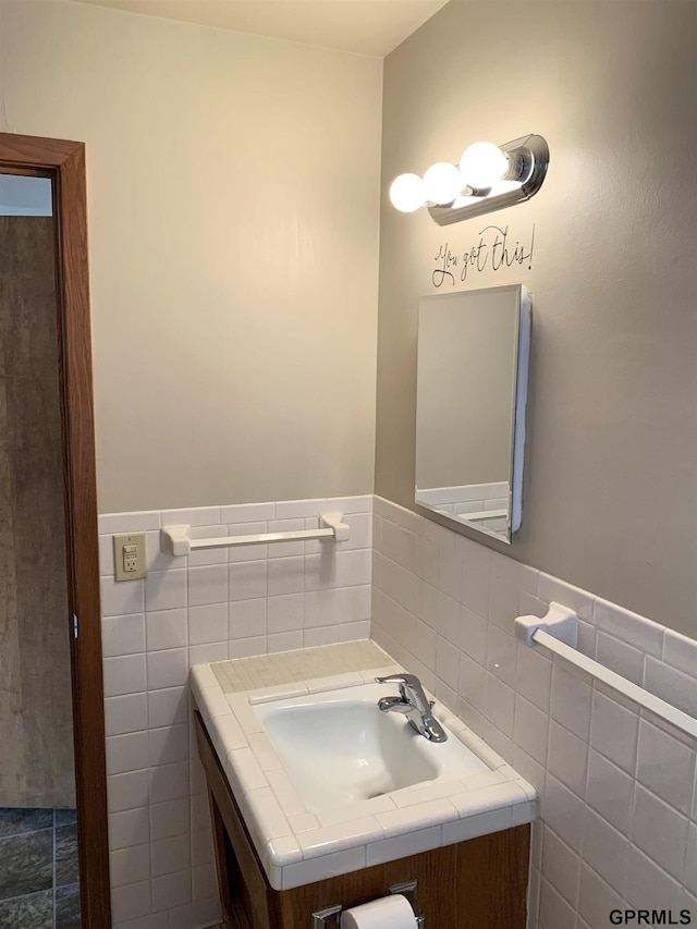 1321 D St, Lincoln, NE 68502 - bathroom with vanity, tile walls, and wainscoting