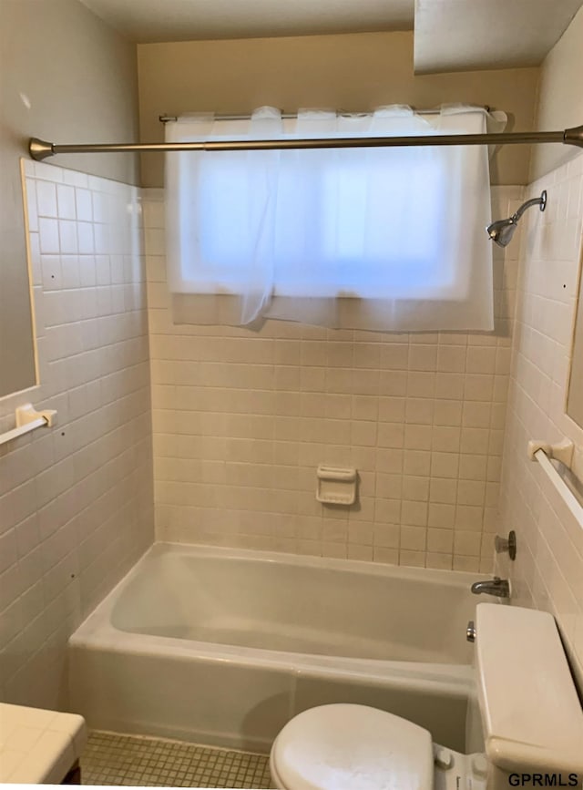 1321 D St, Lincoln, NE 68502 - full bathroom with tile walls, tile patterned floors, healthy amount of natural light, and bathtub / shower combination