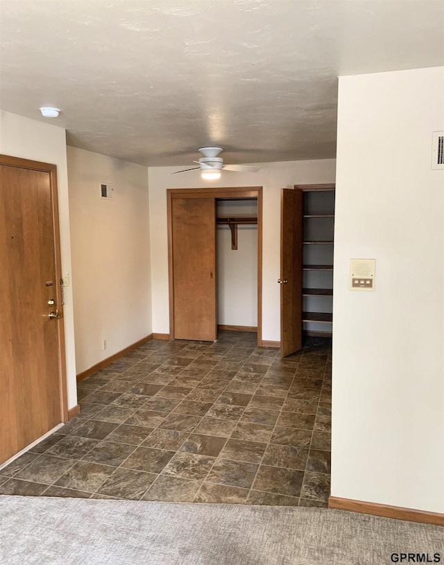 1321 D St, Lincoln, NE 68502 - spare room featuring ceiling fan, a smoke detector, and dark stone finish flooring
