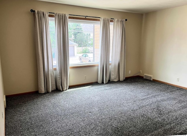 1321 D St, Lincoln, NE 68502 - empty room featuring carpet flooring and baseboards