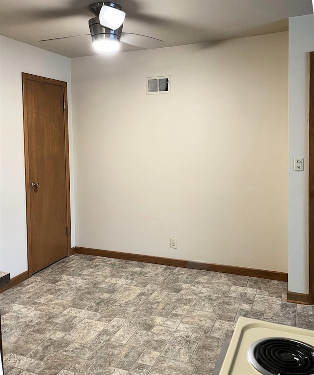 1321 D St, Lincoln, NE 68502 - spare room featuring a ceiling fan and stone finish flooring