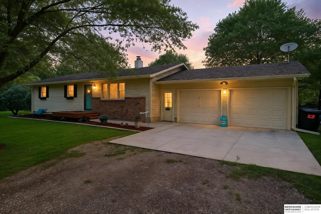 6848 E Military Ave, Fremont, NE 68025 - single story home featuring driveway, a garage, a chimney, and a front yard