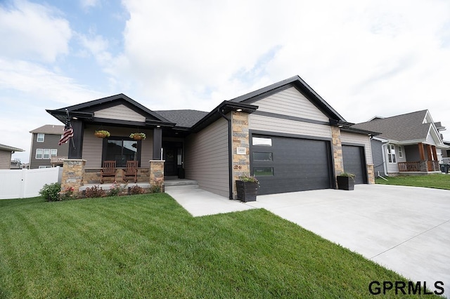 1600 W Avalanche Rd, Lincoln, NE 68521 - view of front of home featuring an attached garage, driveway, a porch, and stone siding