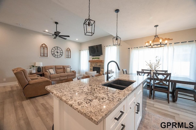 1600 W Avalanche Rd, Lincoln, NE 68521 - kitchen featuring light wood-style floors, healthy amount of natural light, a fireplace, decorative light fixtures, and recessed lighting
