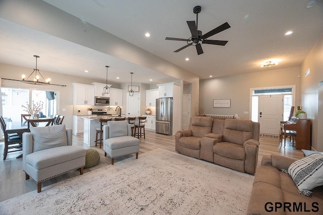 1600 W Avalanche Rd, Lincoln, NE 68521 - living area featuring light wood-style flooring, recessed lighting, a ceiling fan, and a chandelier
