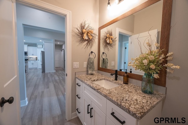 1600 W Avalanche Rd, Lincoln, NE 68521 - bathroom featuring wood finished floors and vanity