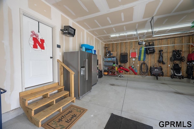 1600 W Avalanche Rd, Lincoln, NE 68521 - garage with stainless steel refrigerator with ice dispenser and a garage door opener