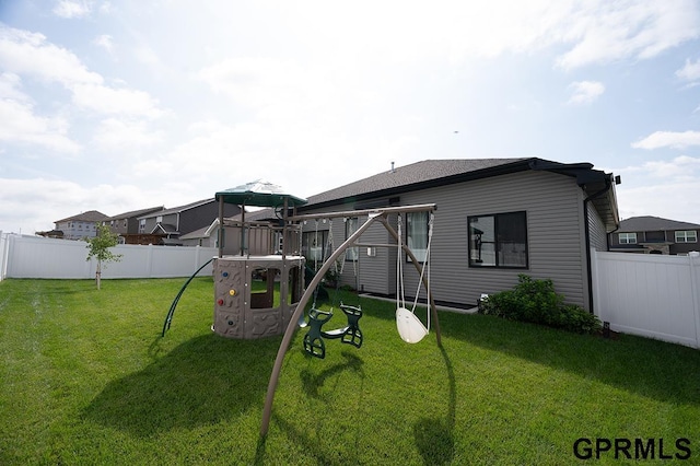 1600 W Avalanche Rd, Lincoln, NE 68521 - back of house featuring a playground and a fenced backyard