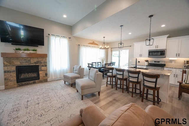 1600 W Avalanche Rd, Lincoln, NE 68521 - living room with light wood-type flooring, recessed lighting, and a fireplace