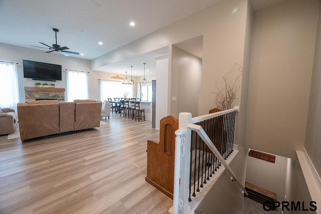 1600 W Avalanche Rd, Lincoln, NE 68521 - living room featuring a stone fireplace, ceiling fan, light wood-type flooring, and recessed lighting