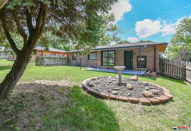 1210 S 44th St, Lincoln, NE 68510 - back of house featuring brick siding and a patio area