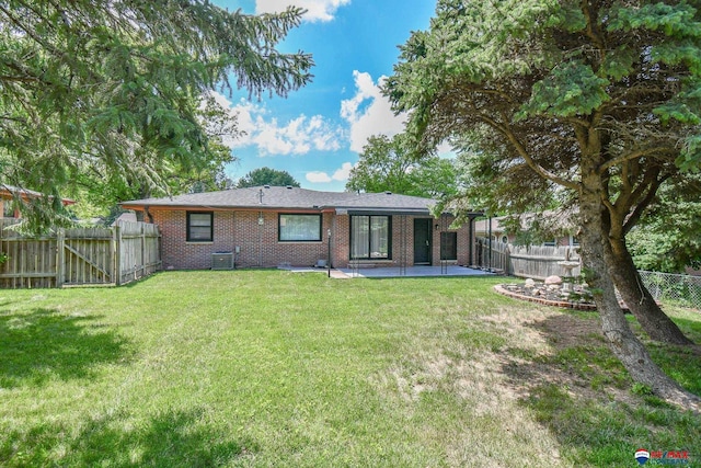 1210 S 44th St, Lincoln, NE 68510 - rear view of house featuring a patio area, brick siding, and a fenced backyard
