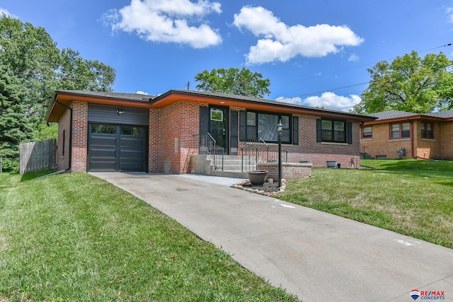 1210 S 44th St, Lincoln, NE 68510 - ranch-style house with concrete driveway, brick siding, a front lawn, and an attached garage