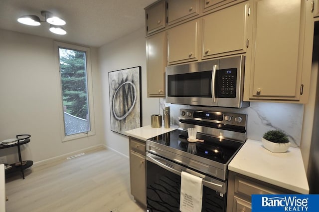 7101 S St Unit 1, Lincoln, NE 68506 - kitchen with stainless steel appliances, light wood-style flooring, and light countertops