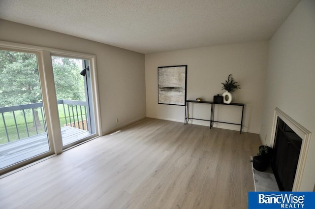 7101 S St Unit 1, Lincoln, NE 68506 - unfurnished living room with wood finished floors and a textured ceiling