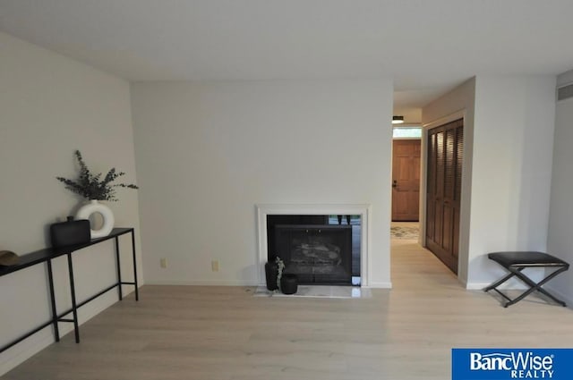 7101 S St Unit 1, Lincoln, NE 68506 - unfurnished living room featuring wood finished floors and a fireplace with flush hearth