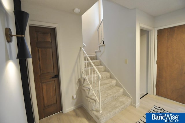 7101 S St Unit 1, Lincoln, NE 68506 - staircase featuring wood finished floors and baseboards