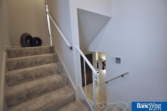 7101 S St Unit 1, Lincoln, NE 68506 - staircase featuring carpet and baseboards
