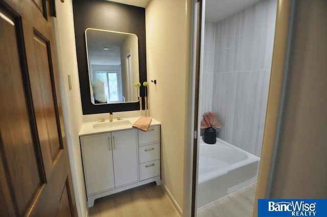 7101 S St Unit 1, Lincoln, NE 68506 - full bath with wood finished floors, vanity, and washtub / shower combination