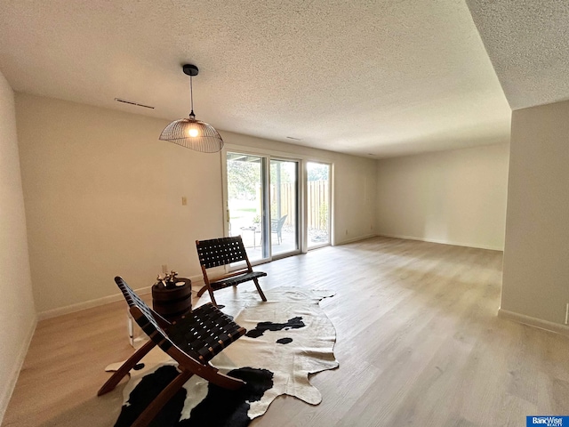 7101 S St Unit 1, Lincoln, NE 68506 - sitting room with a textured ceiling and light wood-type flooring
