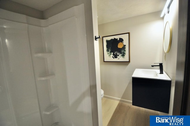 7101 S St Unit 1, Lincoln, NE 68506 - bathroom featuring wood finished floors, vanity, and a shower
