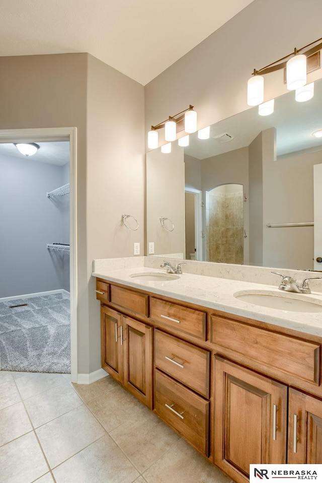 8023 S 193rd St, Gretna, NE 68028 - bathroom featuring double vanity, tile patterned flooring, a walk in closet, and a shower