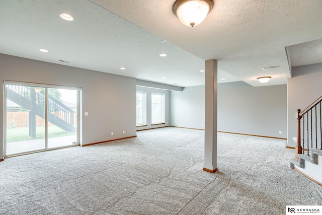 8023 S 193rd St, Gretna, NE 68028 - carpeted spare room featuring stairs, healthy amount of natural light, a textured ceiling, and recessed lighting