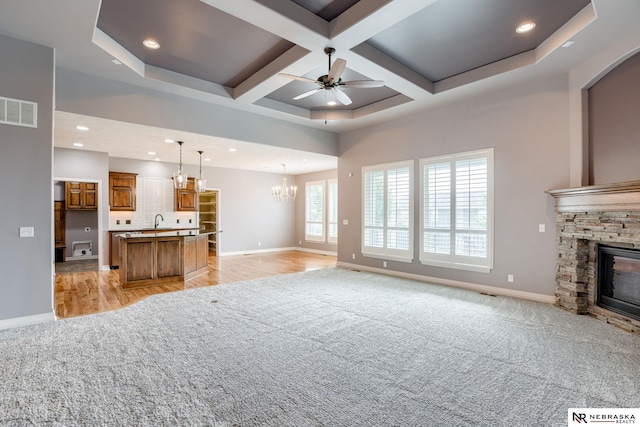 8023 S 193rd St, Gretna, NE 68028 - living area with a fireplace, ceiling fan, light carpet, a chandelier, and coffered ceiling