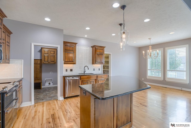 8023 S 193rd St, Gretna, NE 68028 - kitchen featuring stainless steel appliances, light wood finished floors, backsplash, a chandelier, and recessed lighting