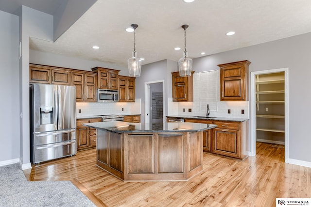 8023 S 193rd St, Gretna, NE 68028 - kitchen with stainless steel appliances, brown cabinets, a kitchen island, and recessed lighting