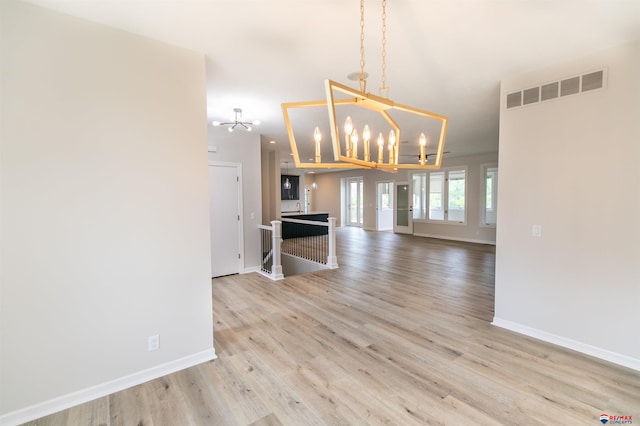 5241 Troon Dr, Lincoln, NE 68526 - unfurnished dining area featuring a chandelier and light wood-type flooring