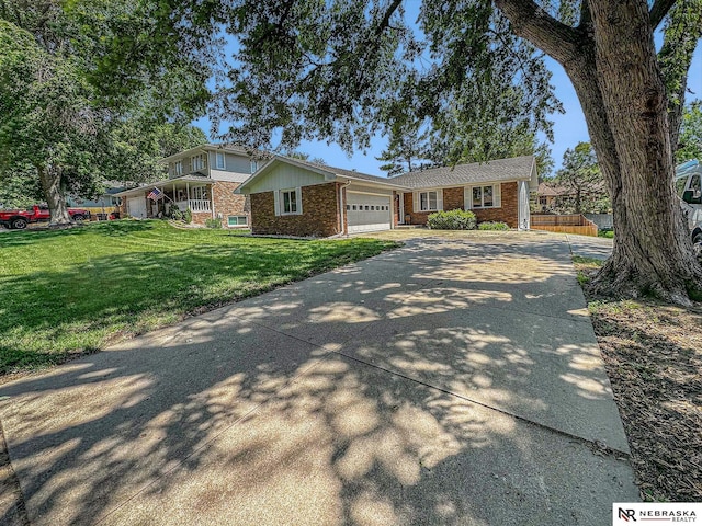 7533 Sherman St, Lincoln, NE 68506 - view of front of property with brick siding, an attached garage, and driveway