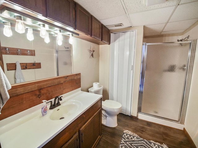 7533 Sherman St, Lincoln, NE 68506 - bathroom featuring vanity, a stall shower, wood finished floors, and a drop ceiling