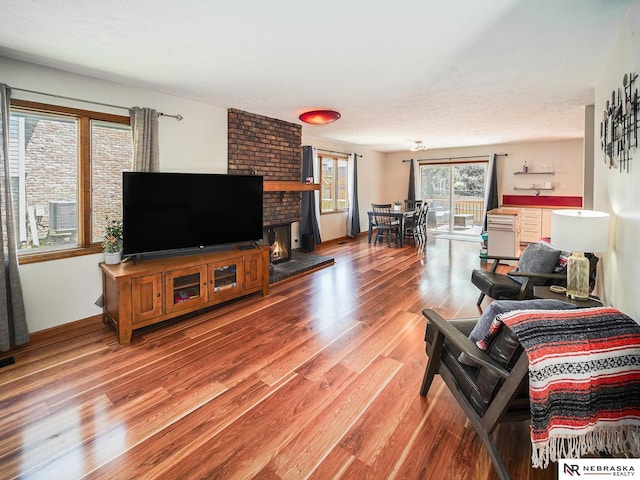 7533 Sherman St, Lincoln, NE 68506 - living room featuring wood finished floors and a fireplace