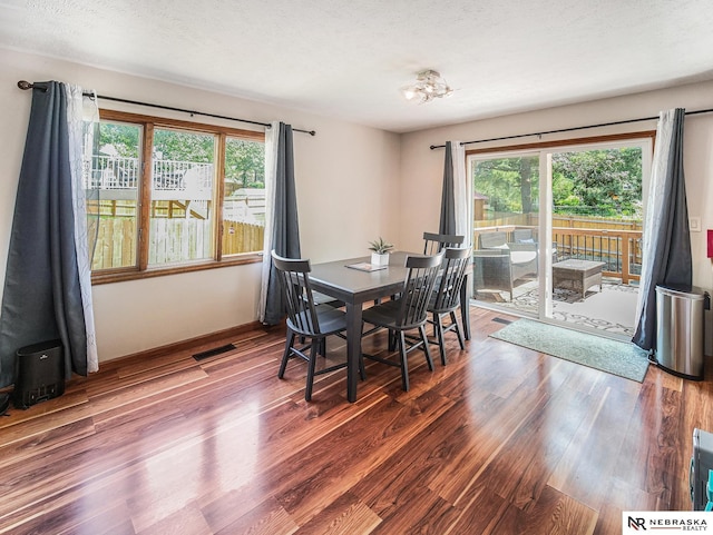 7533 Sherman St, Lincoln, NE 68506 - dining room featuring wood finished floors, a textured ceiling, and a chandelier