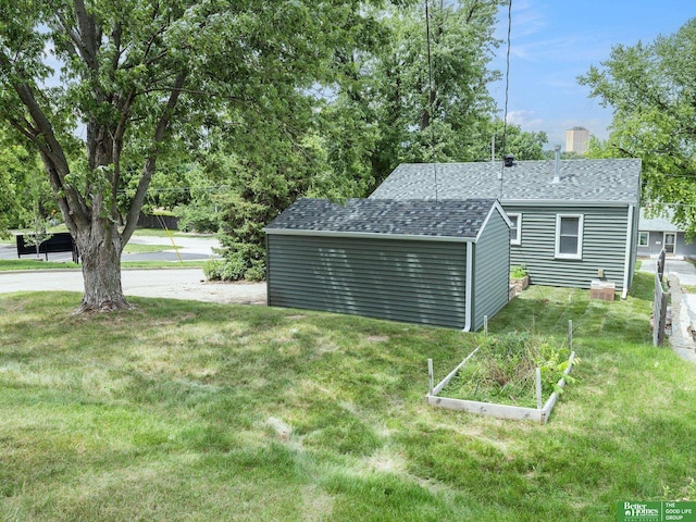5075 Frances St, Omaha, NE 68106 - view of green lawn featuring a vegetable garden and a storage shed