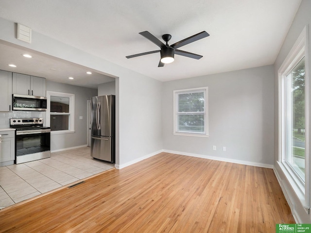 5075 Frances St, Omaha, NE 68106 - unfurnished living room with light wood-type flooring, ceiling fan, and recessed lighting
