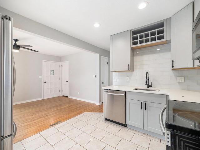 5075 Frances St, Omaha, NE 68106 - kitchen with stainless steel appliances, gray cabinets, light wood-style floors, light countertops, and recessed lighting