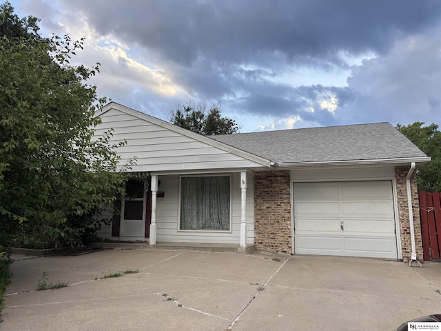 3108 S 134th St, Omaha, NE 68144 - view of front of property with concrete driveway, an attached garage, brick siding, and a shingled roof