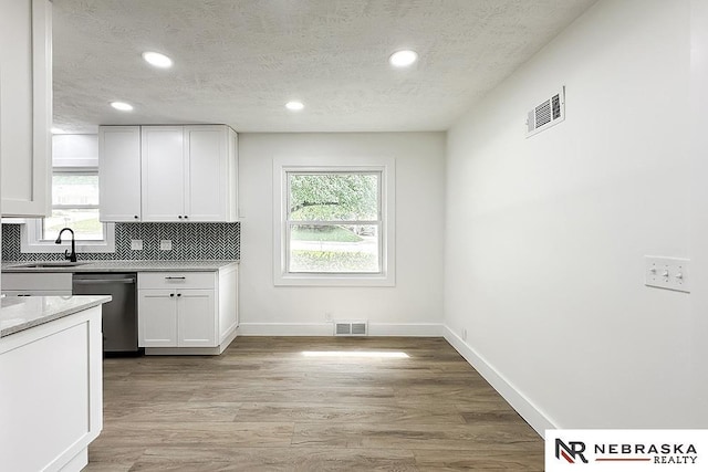 1113 S 94th St, Omaha, NE 68124 - kitchen featuring dishwasher, white cabinets, a textured ceiling, recessed lighting, and decorative backsplash