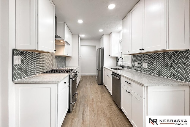 1113 S 94th St, Omaha, NE 68124 - kitchen featuring stainless steel appliances, light wood-style flooring, backsplash, white cabinetry, and recessed lighting