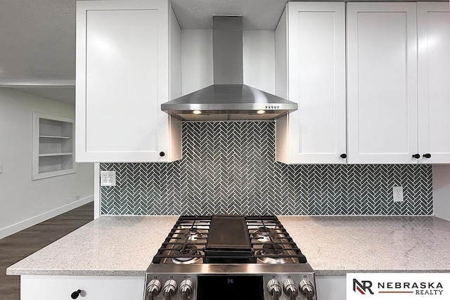1113 S 94th St, Omaha, NE 68124 - kitchen with wall chimney exhaust hood, stainless steel range oven, light countertops, white cabinetry, and dark wood-style flooring