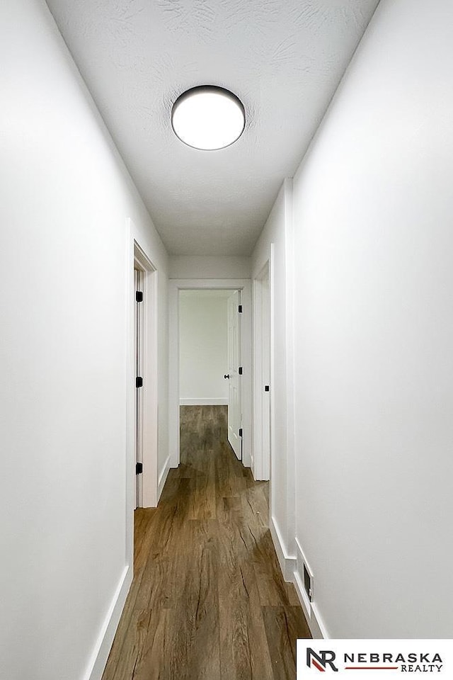 1113 S 94th St, Omaha, NE 68124 - hallway with dark wood-style flooring and baseboards