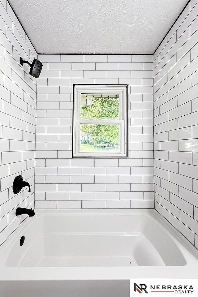 1113 S 94th St, Omaha, NE 68124 - bathroom featuring a textured ceiling and tub / shower combination