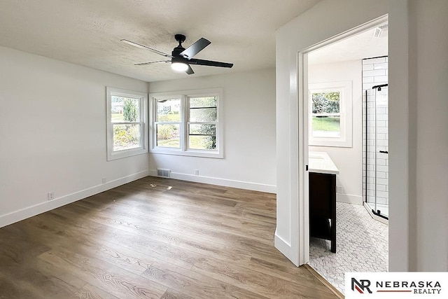 1113 S 94th St, Omaha, NE 68124 - spare room featuring healthy amount of natural light, wood finished floors, and ceiling fan